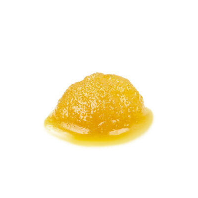 Golden yellow cannabis live resin sauce pink bubba strain with glossy, syrupy texture on a white background